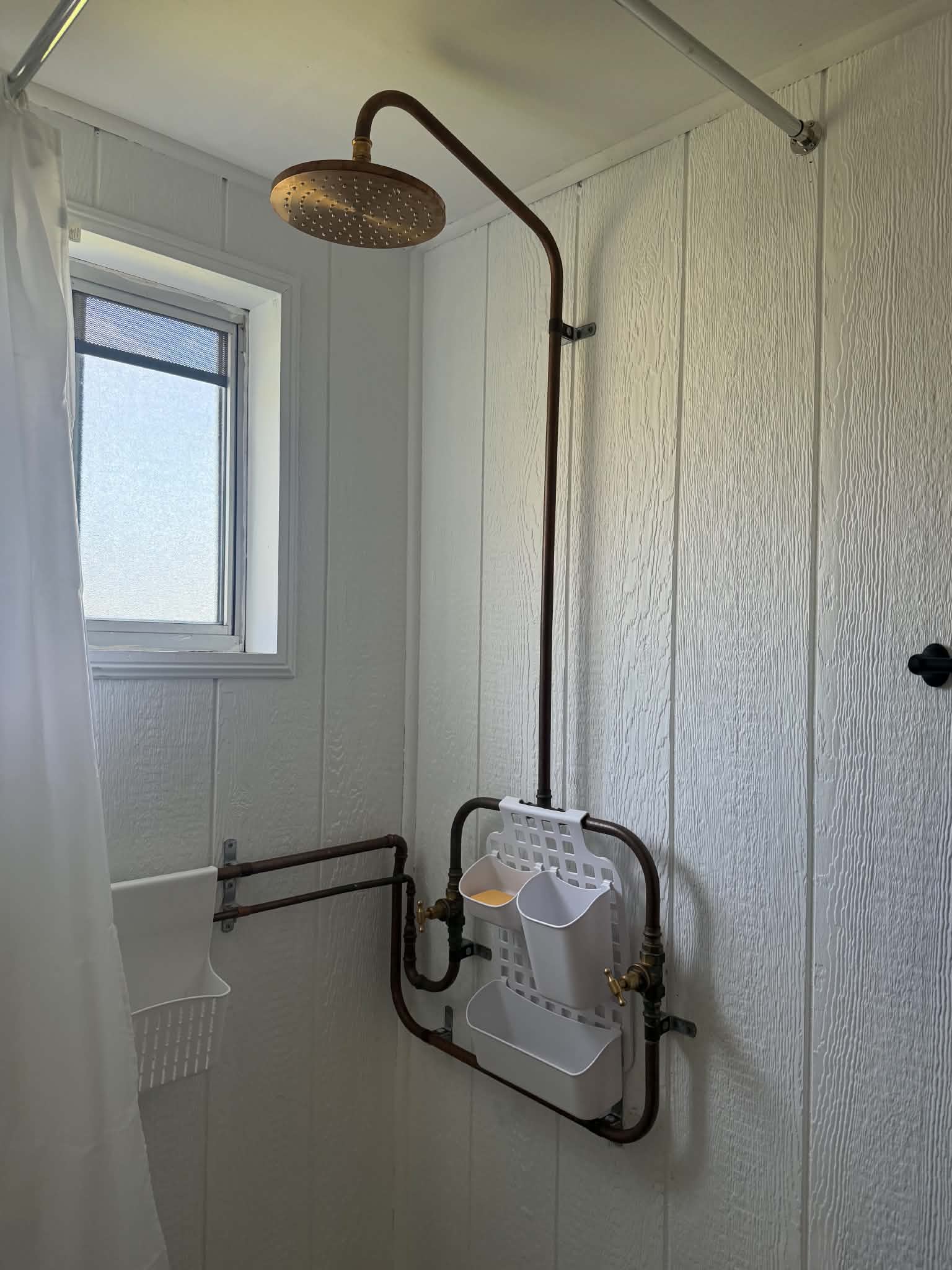 Exposed copper pipe shower renovation with rain shower head