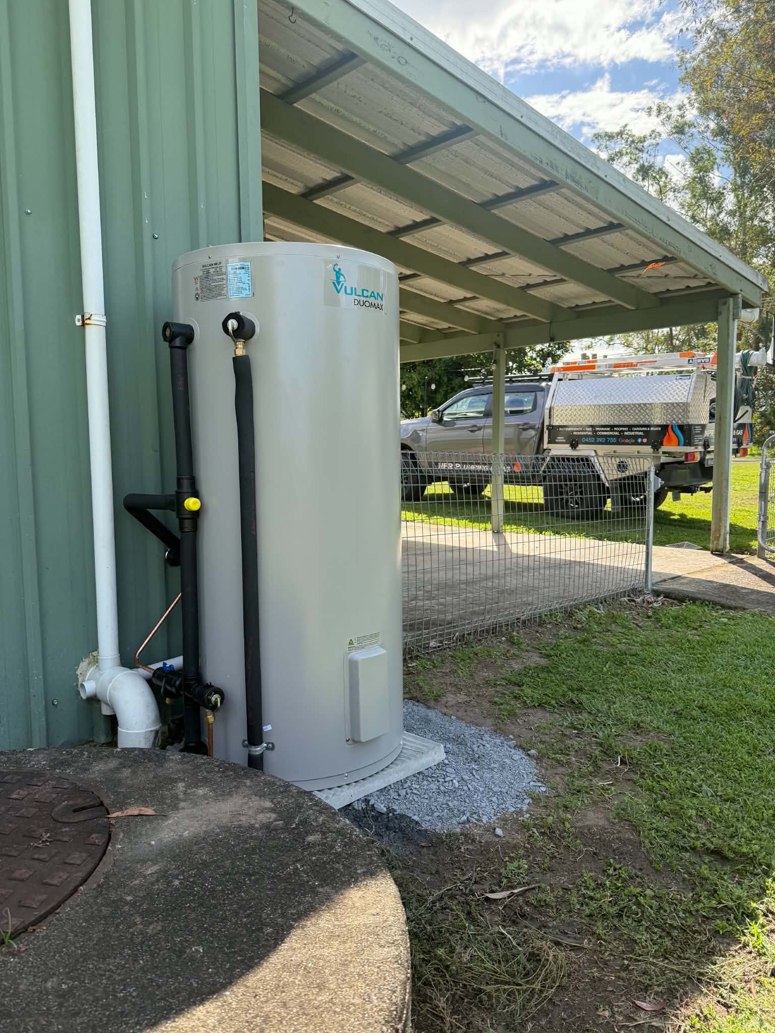 Vulcan Duomax hot water system installation beside a shed